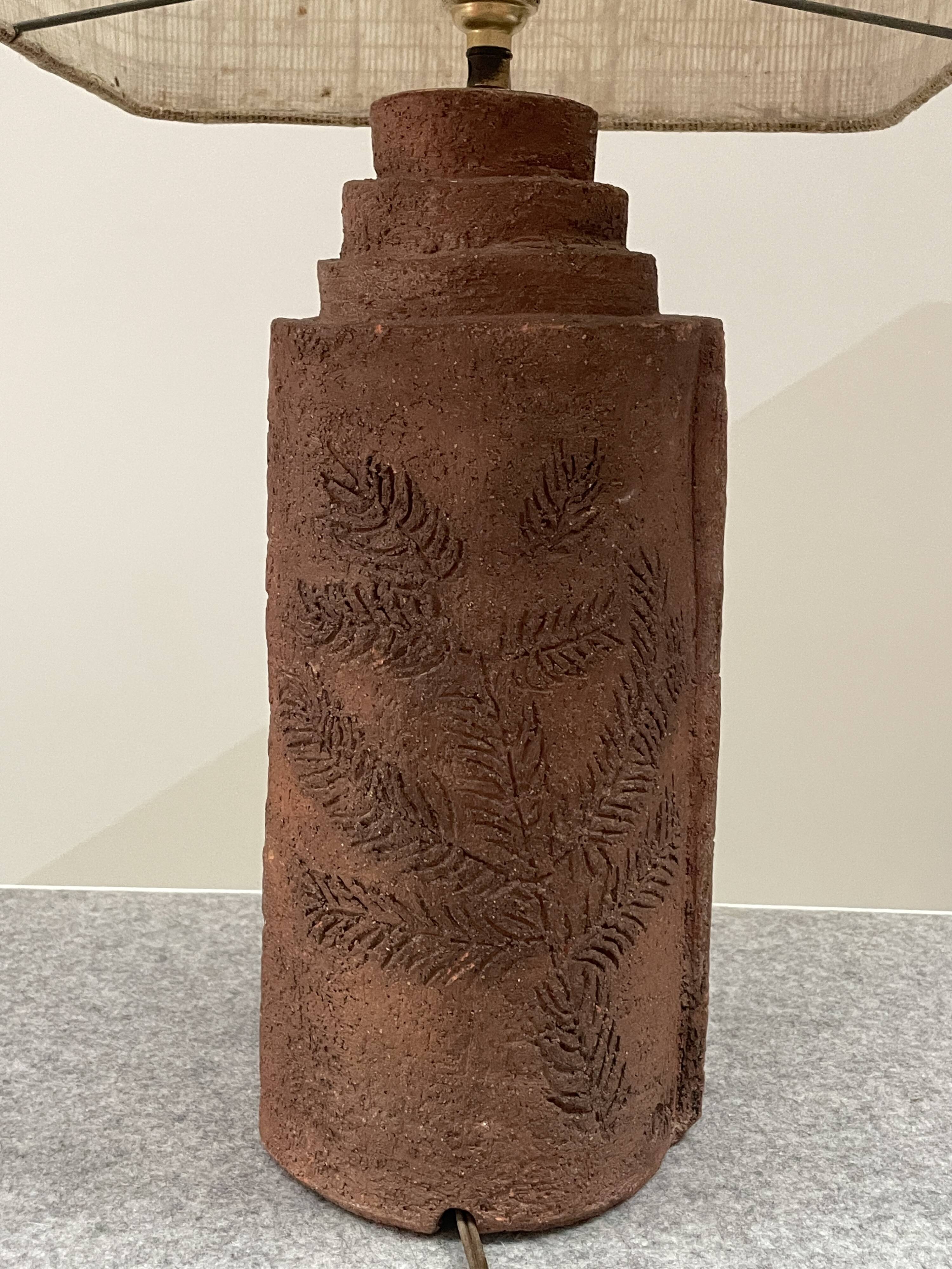 Large chamotte clay lamp in brutalist style, with a plant motif.