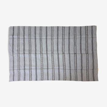 Handwoven vintage geometrical rug, grey background