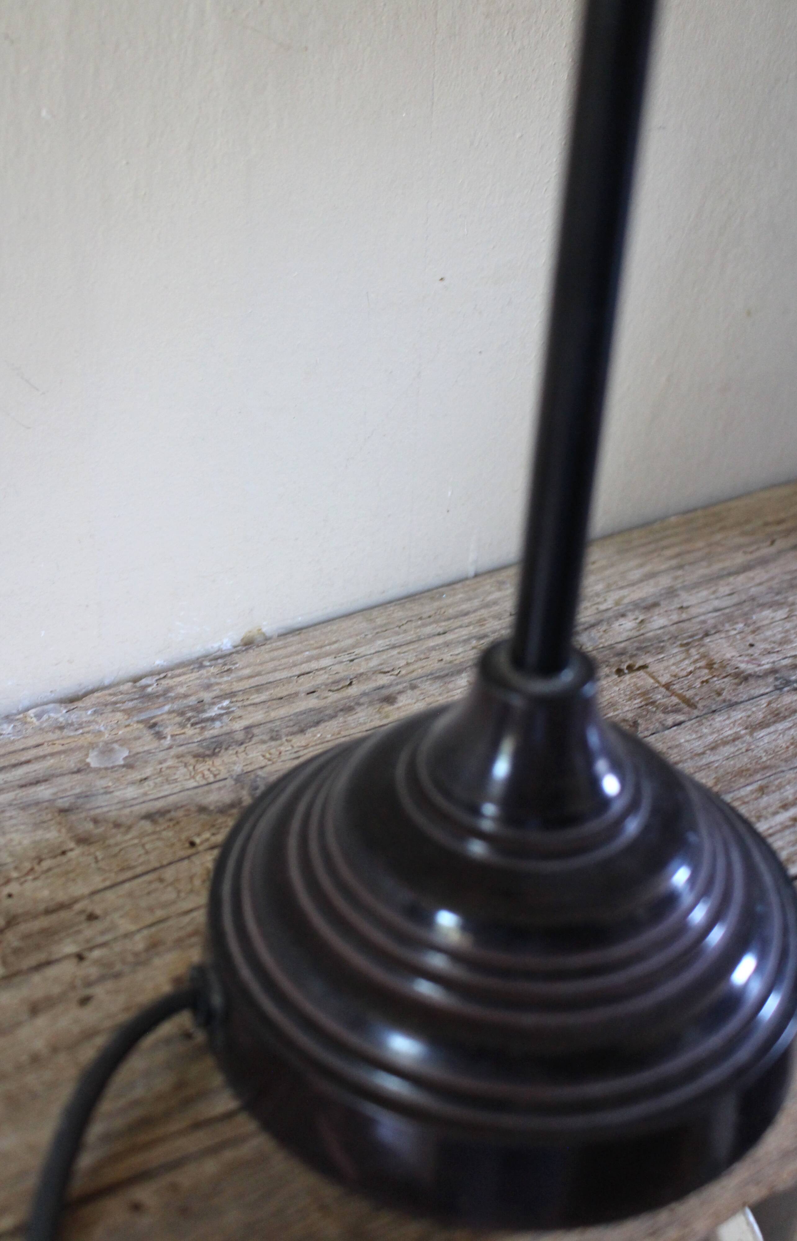 Table lamp with a patinated base and vintage woven shade.