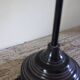 Table lamp with a patinated base and vintage woven shade.