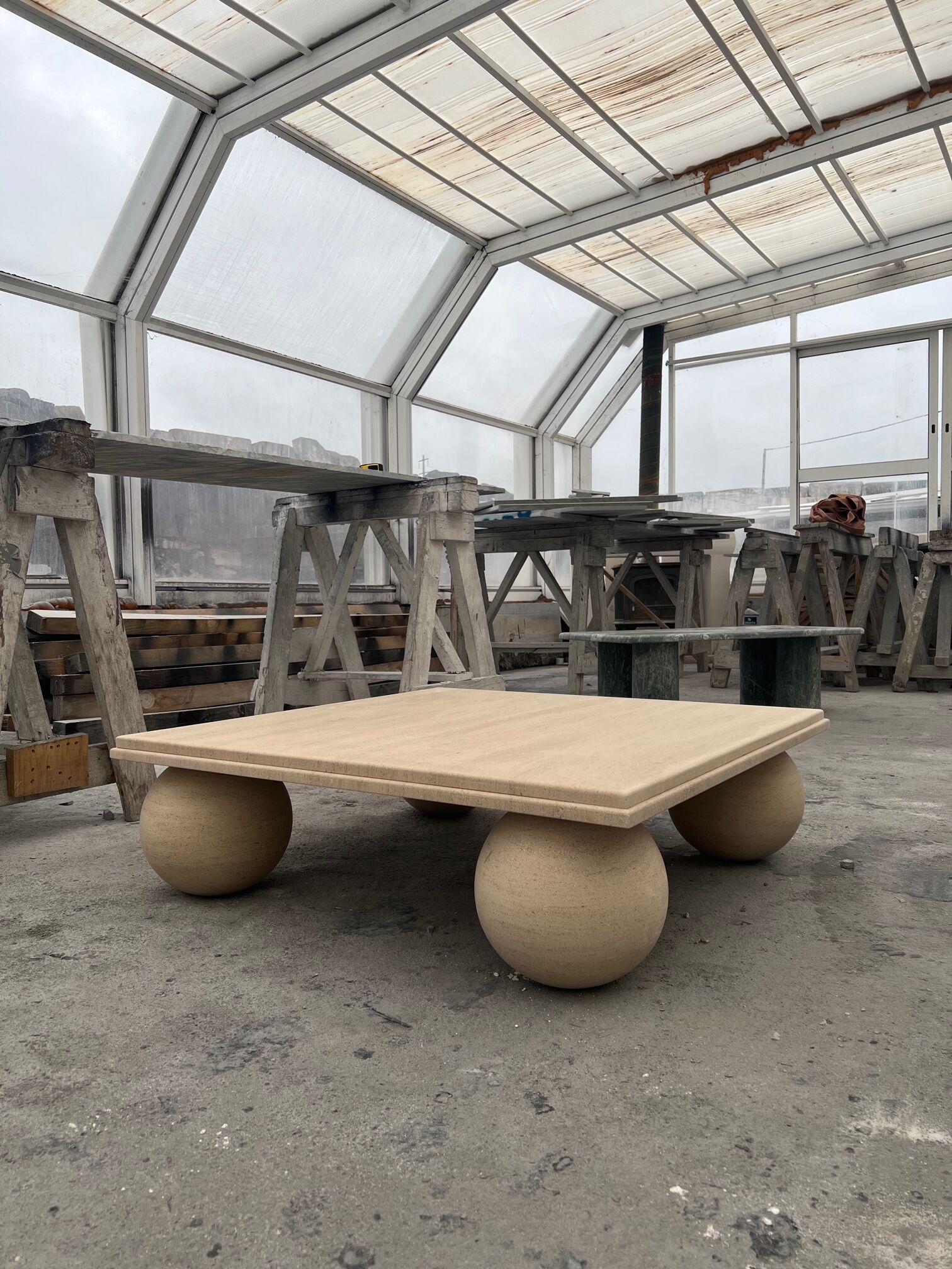 Square stone coffee table with sculptural ball legs