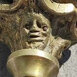 Baroque/Antique style torch candleholder, nineteenth, gilded bronze. Head motifs, volute arabesques