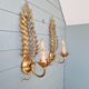 Pair of gold metal wall sconces in Hollywood Regency style, 1970s.