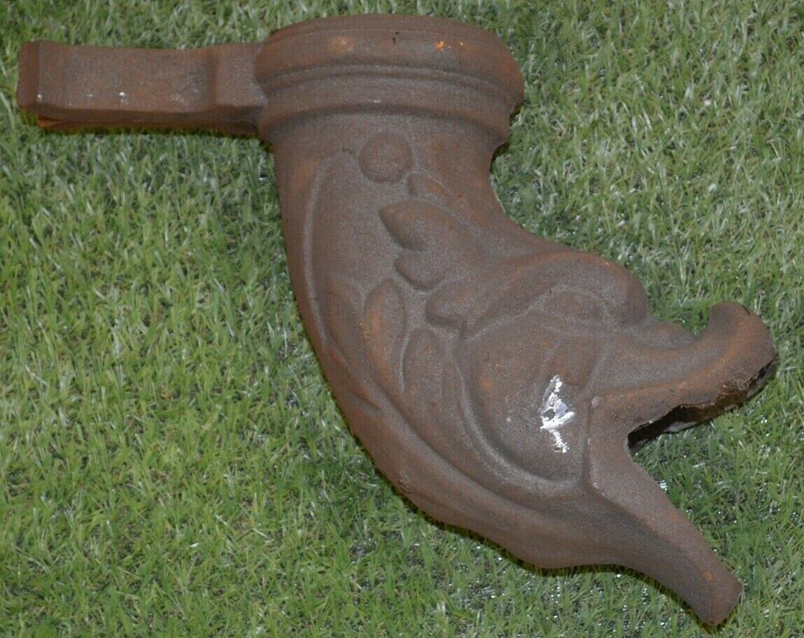 Cast iron gutter downspout in the shape of a dolphin