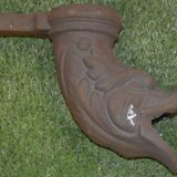 Cast iron gutter downspout in the shape of a dolphin