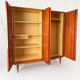 Vintage 1970s wardrobe with floral marquetry, mirrors, and gold details.