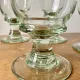 4 stemmed glasses made of handcrafted blown glass in green hue.