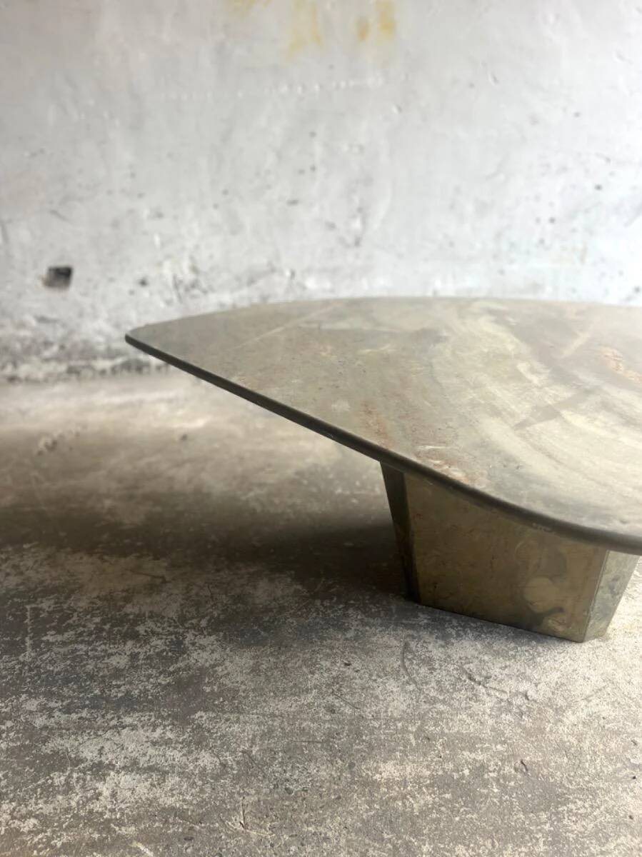 Light gray solid granite coffee table with organic triangular shape and conical base, 1980s