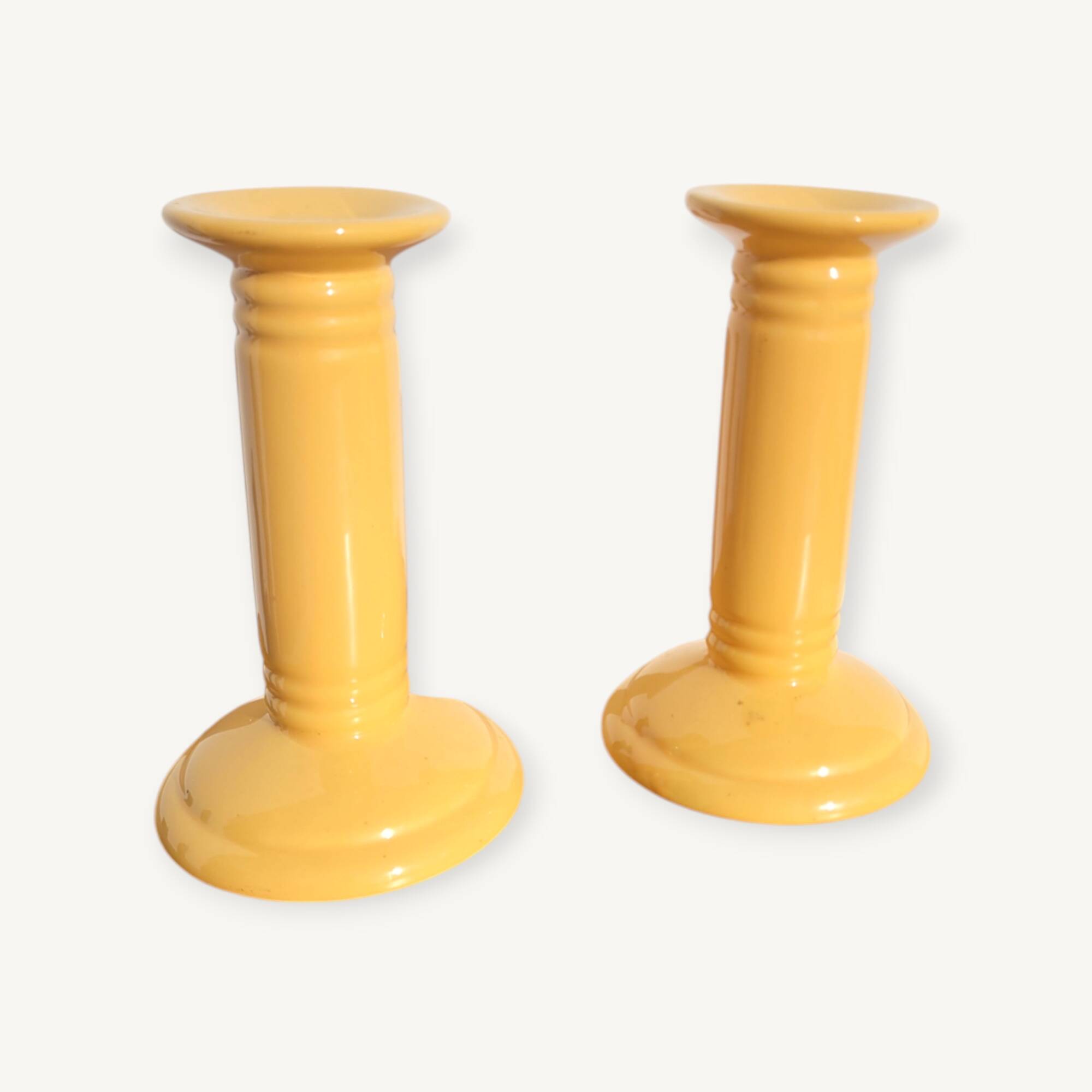 Pair of yellow ceramic candlesticks