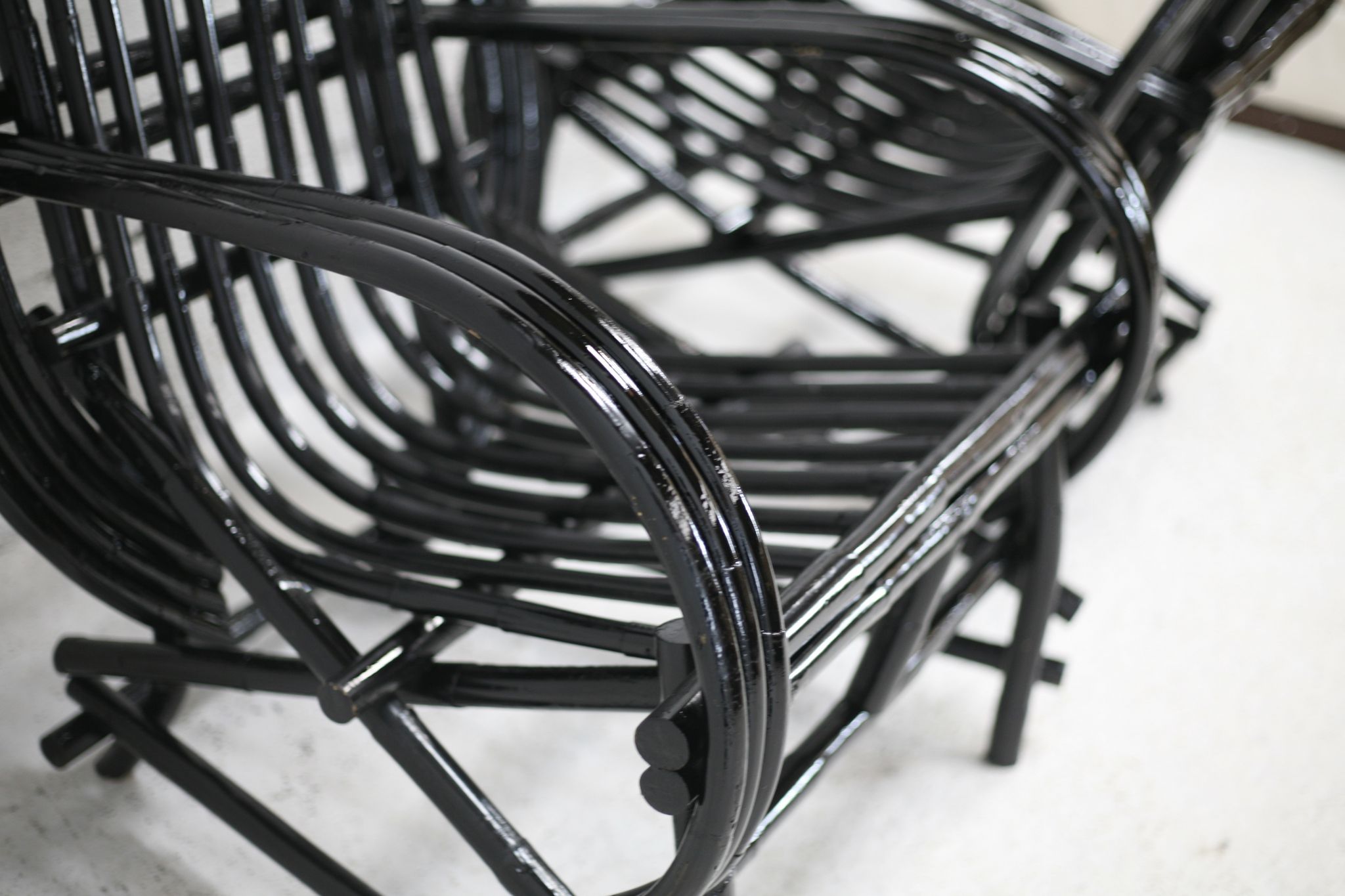 Pair of black lacquered rattan armchairs. France, cira 1960.