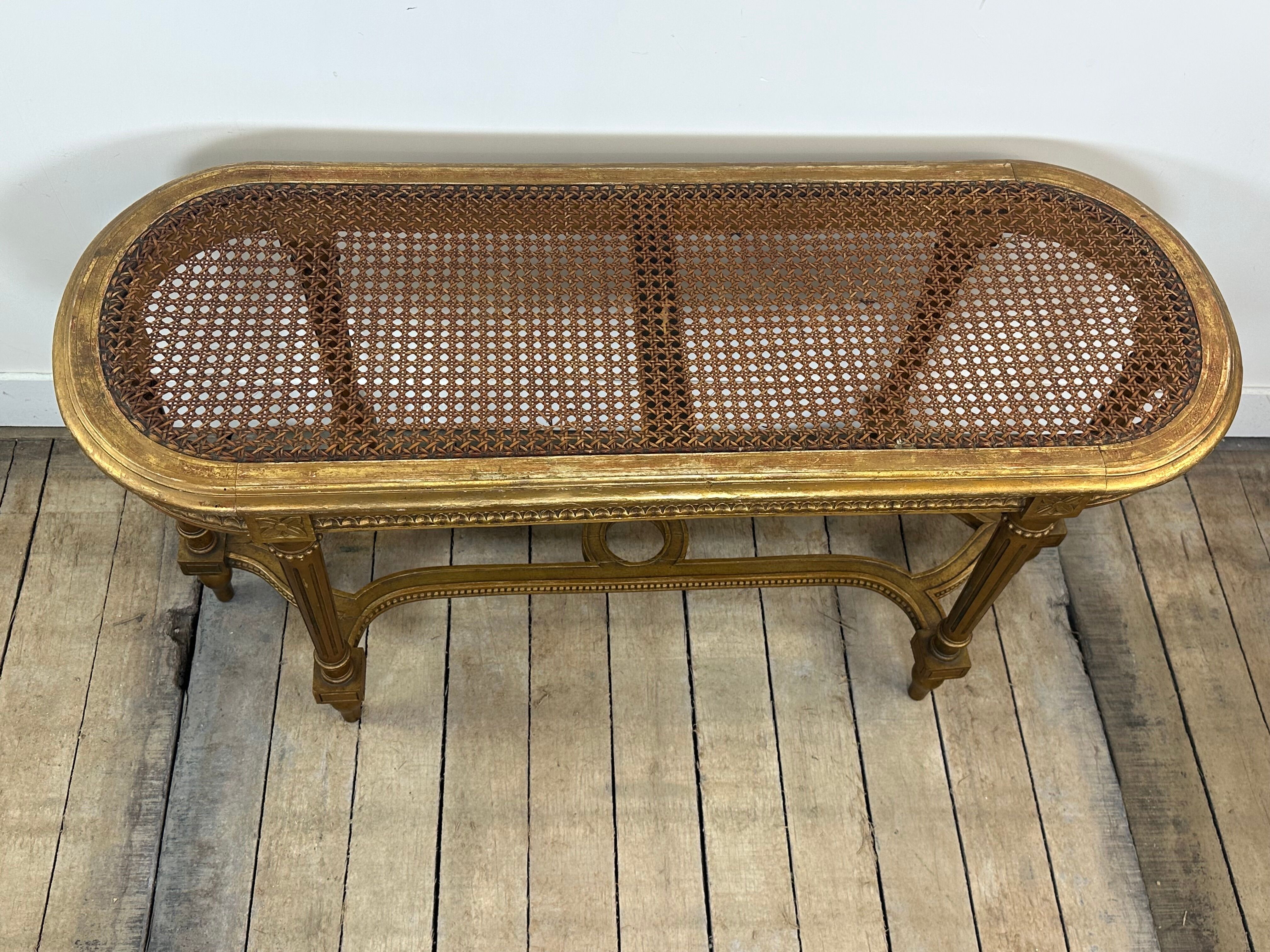 Banquette cannée dorée de style Louis XV
