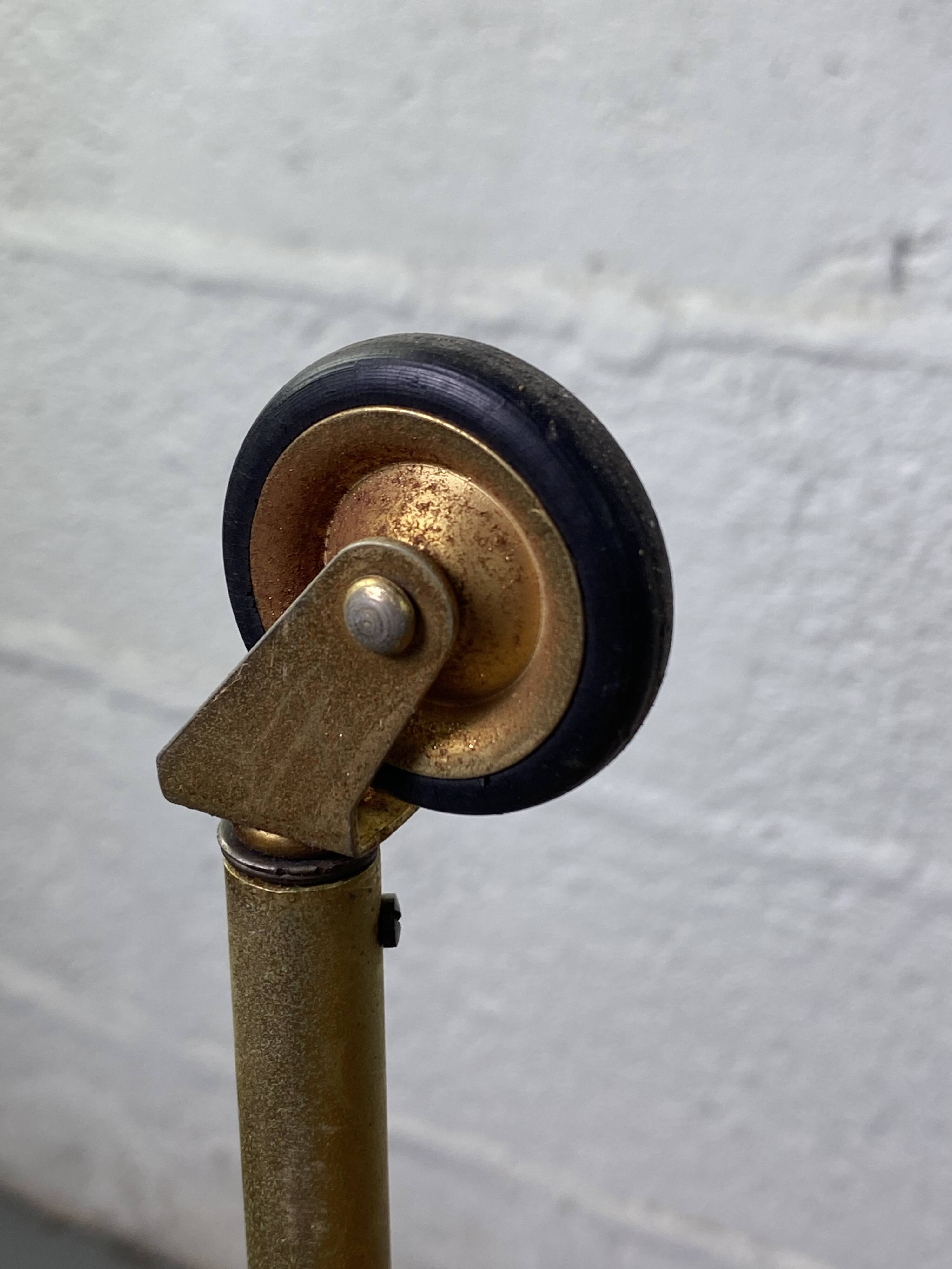 Small rolling trolley in brass and black plastic