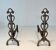 Pair of Brass and Wrought Iron Chenets with Scroll Columns and Arched Bases