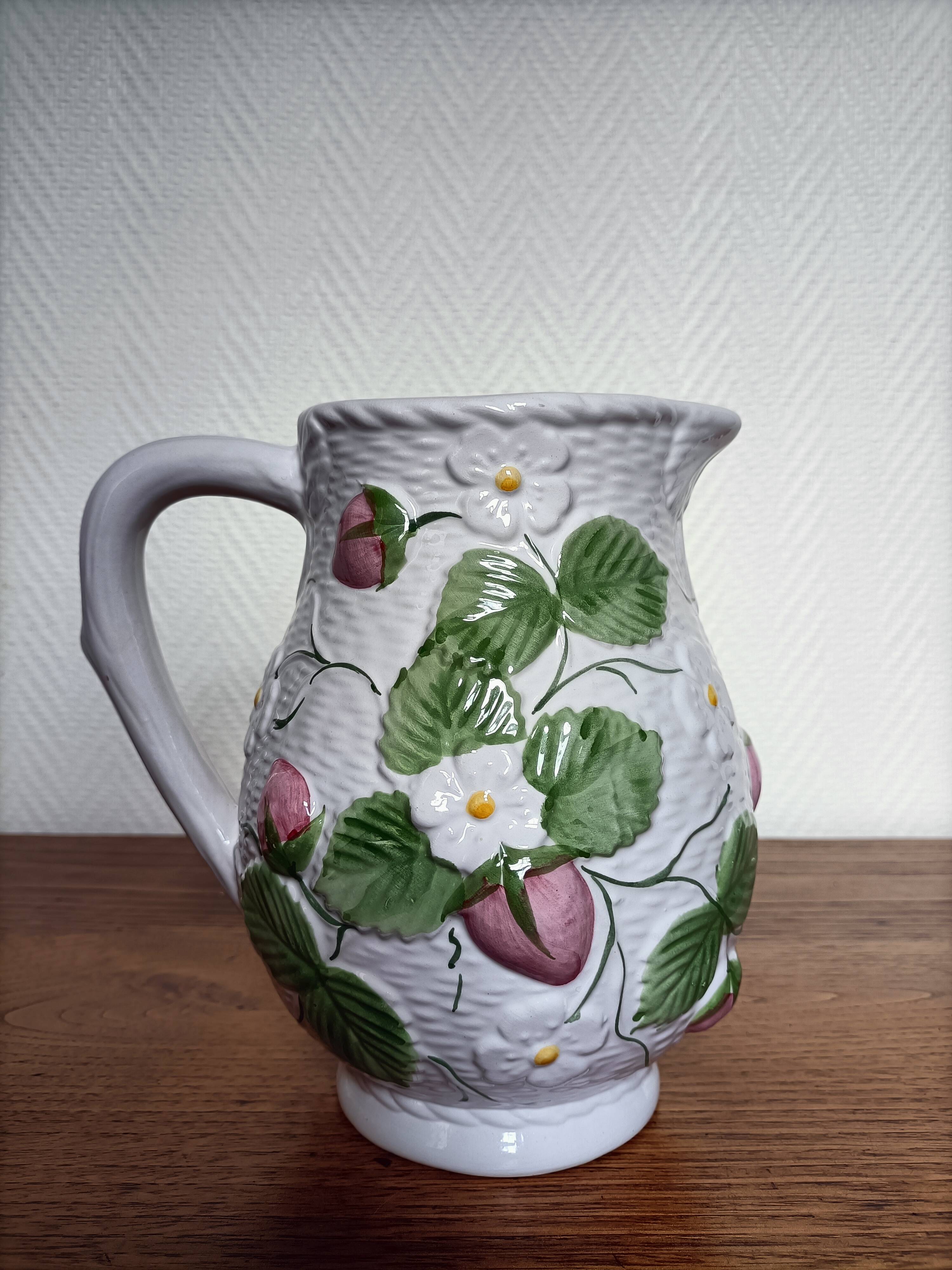 Barbotine pitcher with pastel flower decoration