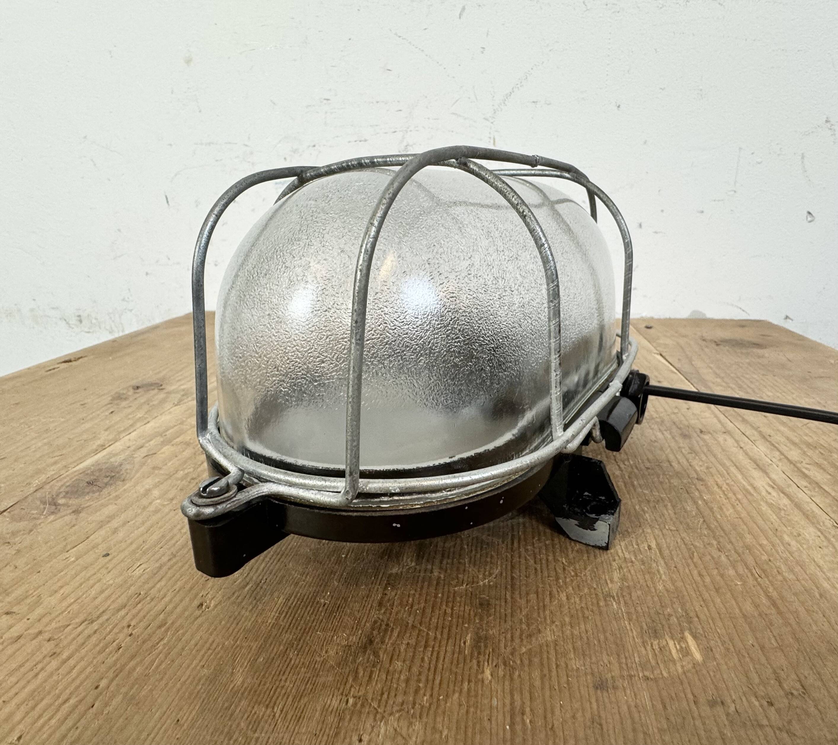 Industrial brown bakelite wall light with frosted glass, 1960s