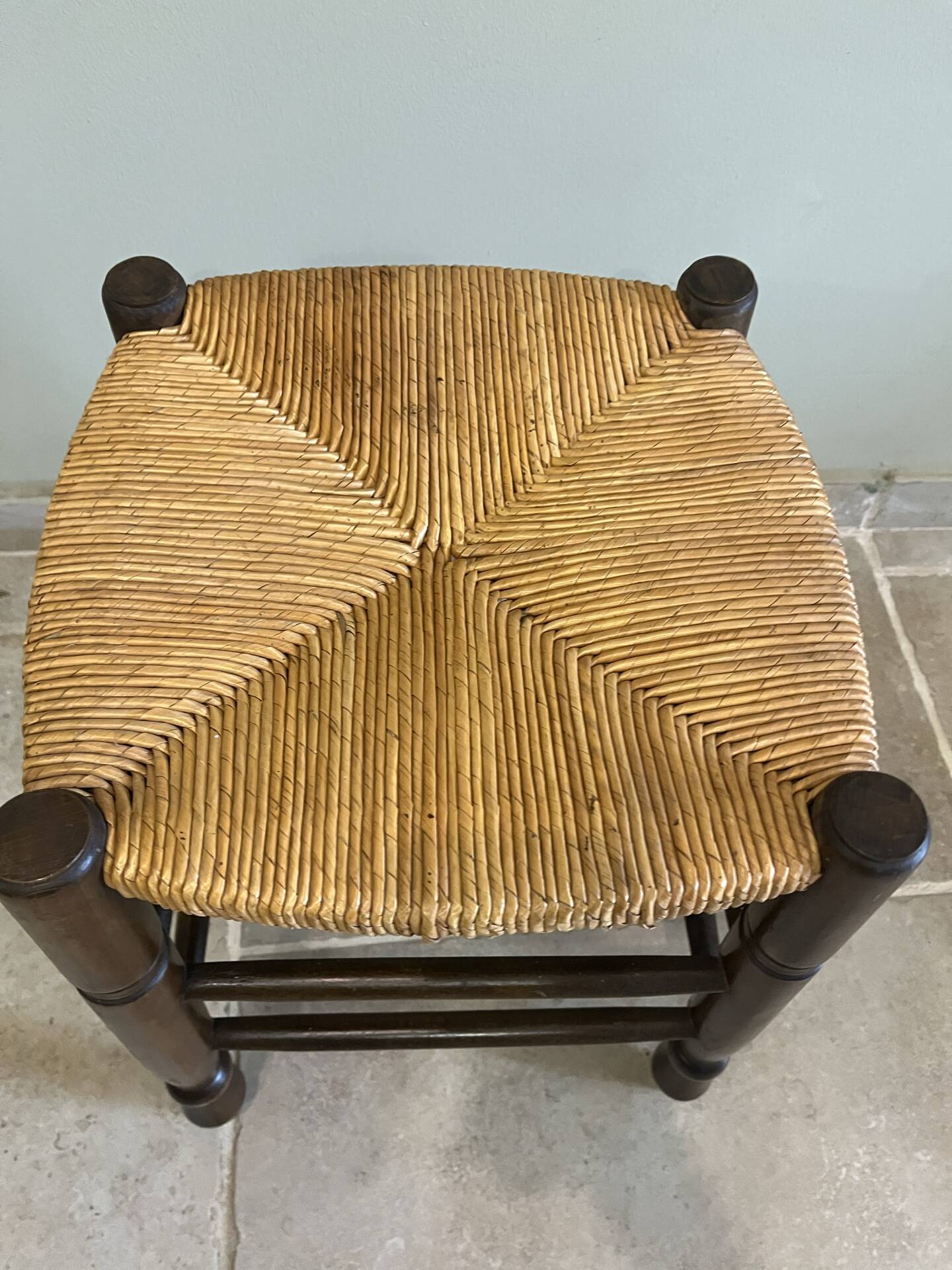 Wooden stool with a straw seat