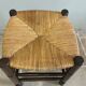 Wooden stool with a straw seat