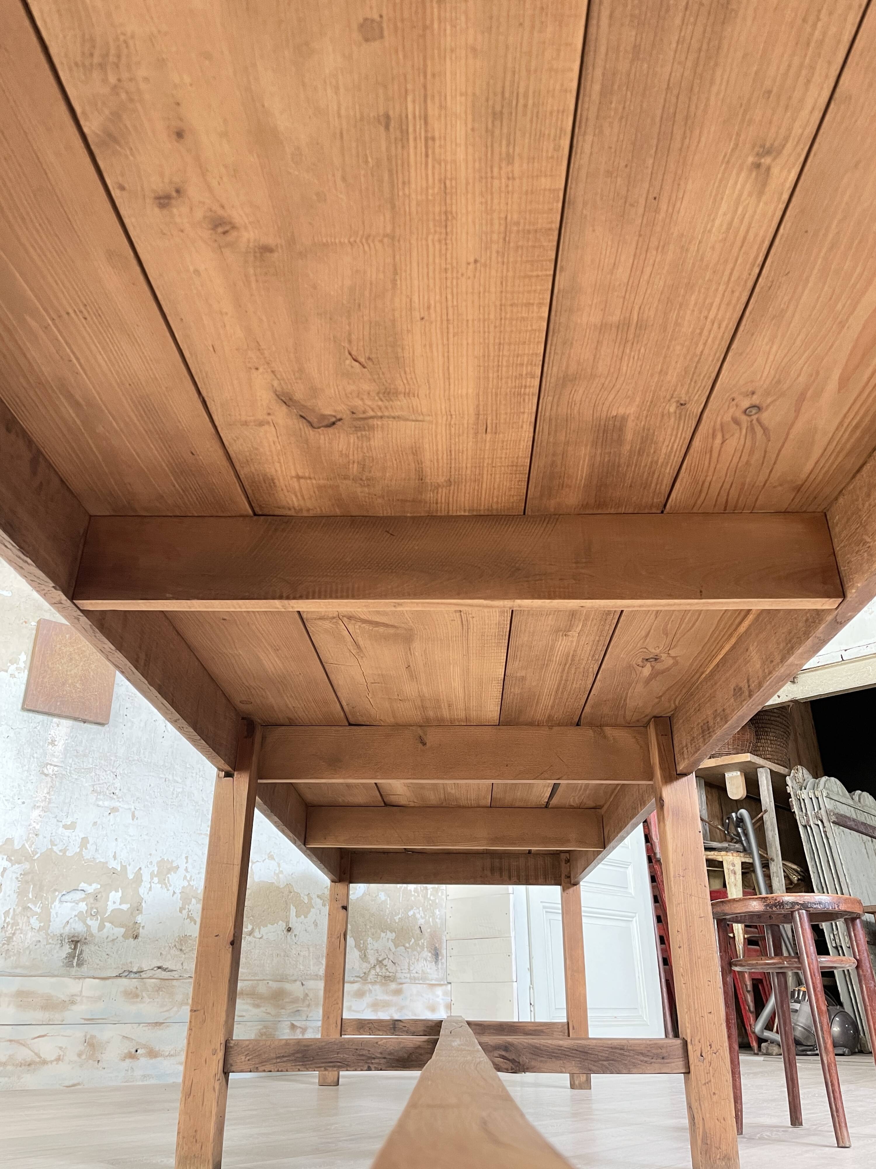 Solid wood workshop table with straight legs.