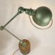Jielde table lamp with 2 arms on a wooden base.