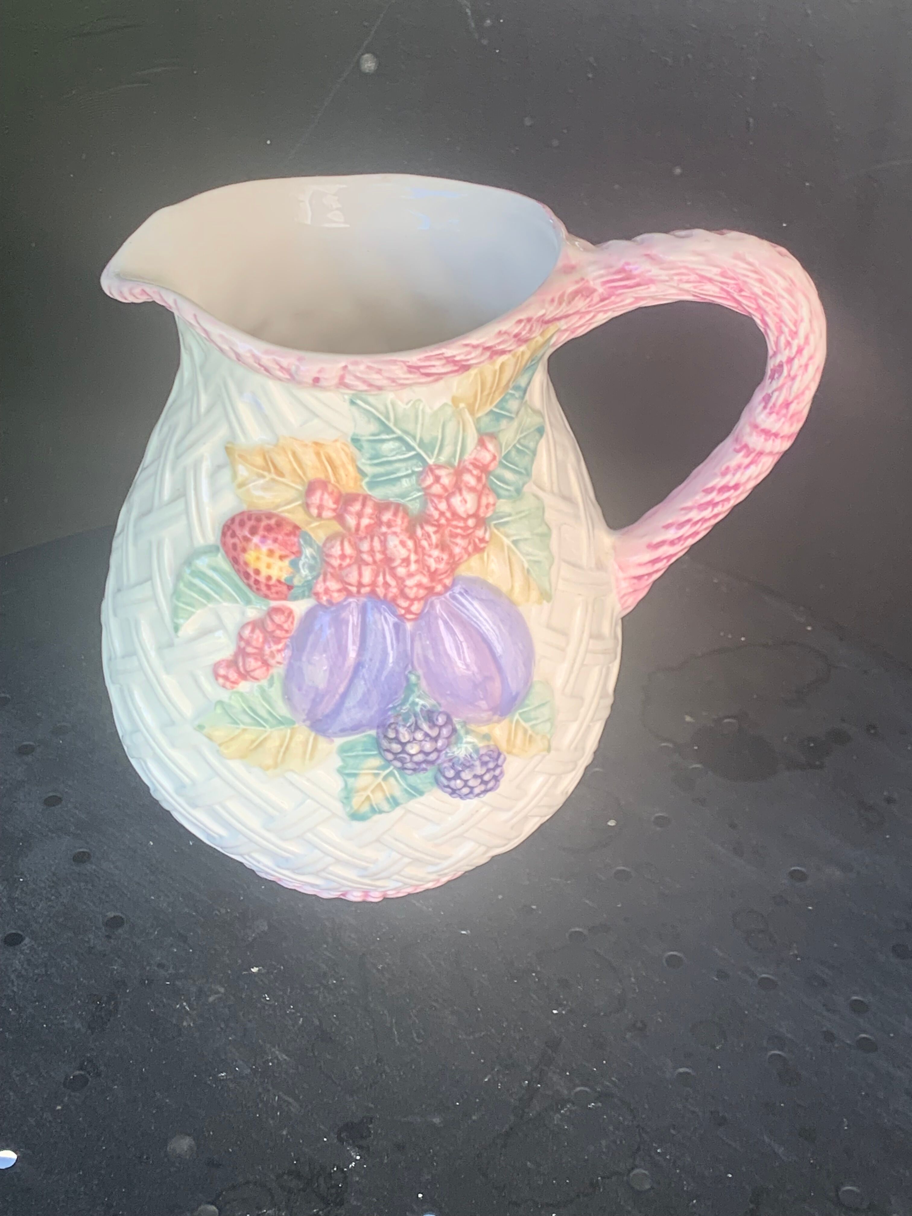 Glazed ceramic slip jug with vintage basket and fruit motif
