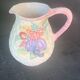 Glazed ceramic slip jug with vintage basket and fruit motif