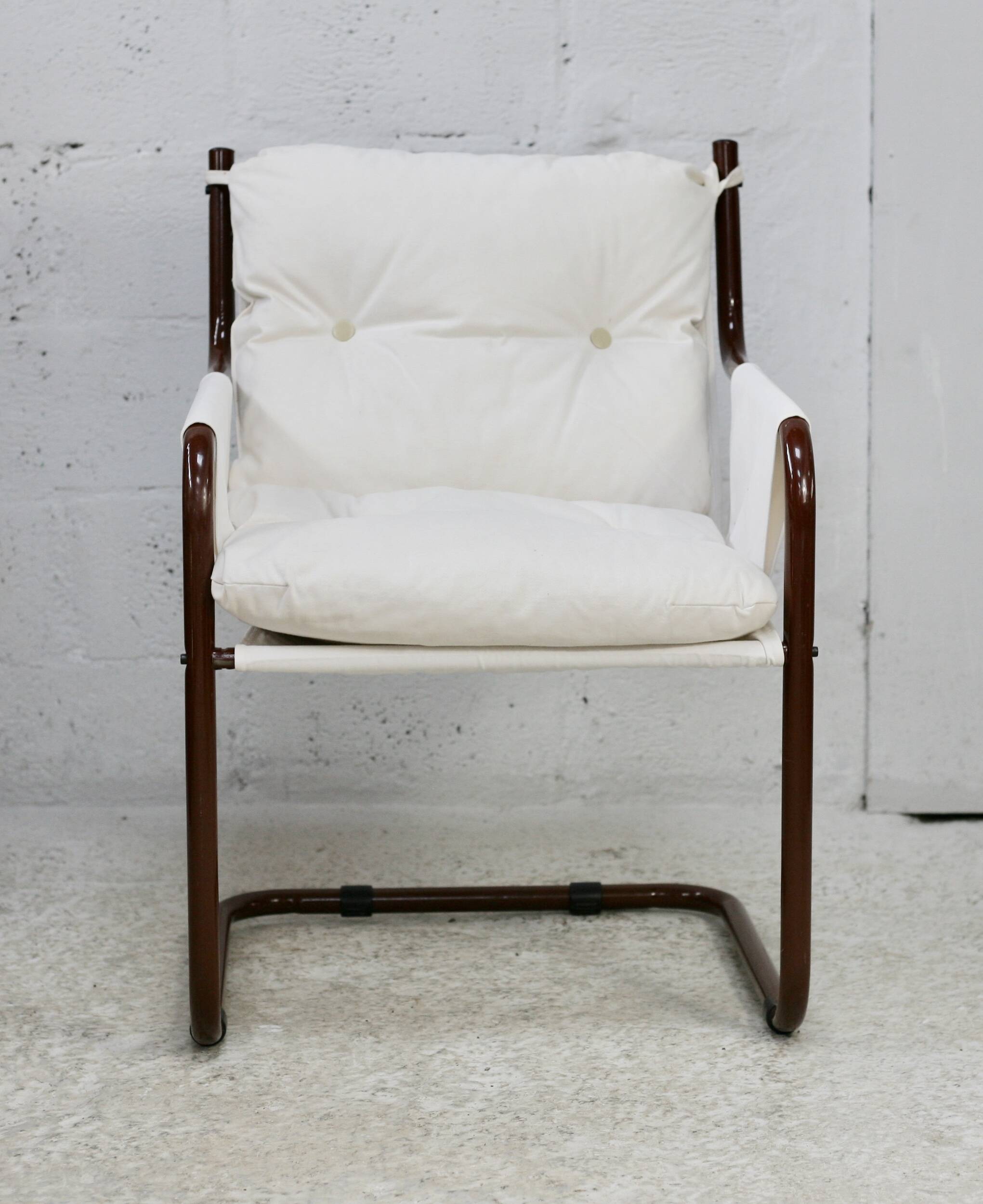 Tubular armchair, fabric suspended seat. Circa 1970