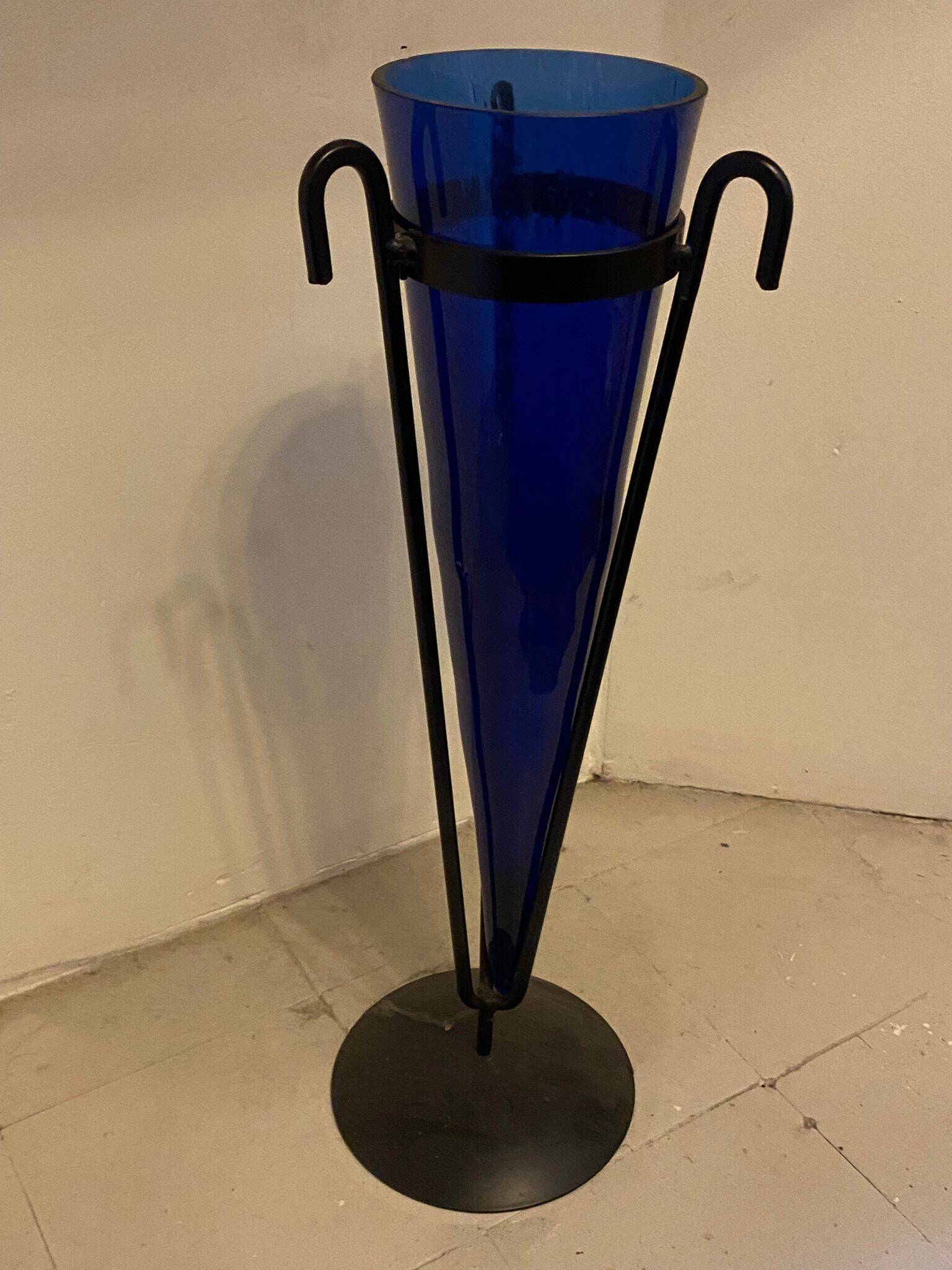 Cobalt blue vase on a metal structure.