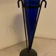 Cobalt blue vase on a metal structure.