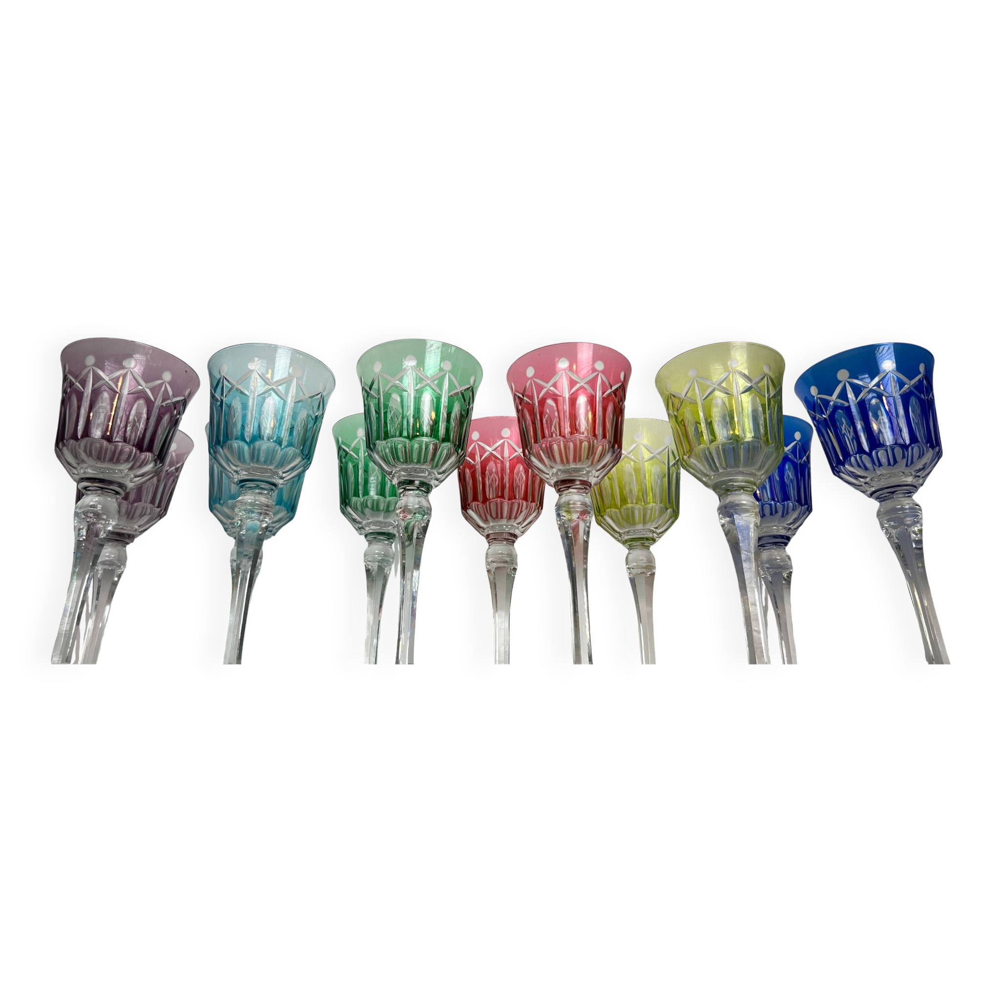 Set of twelve glasses in crystal tinted in different colours and cut with stars.