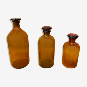 Trio of ancient apothecary bottles of beautiful amber color.