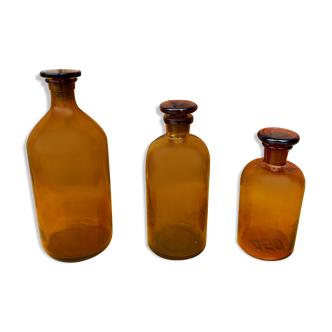 Trio of ancient apothecary bottles of beautiful amber color.
