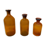 Trio of ancient apothecary bottles of beautiful amber color.