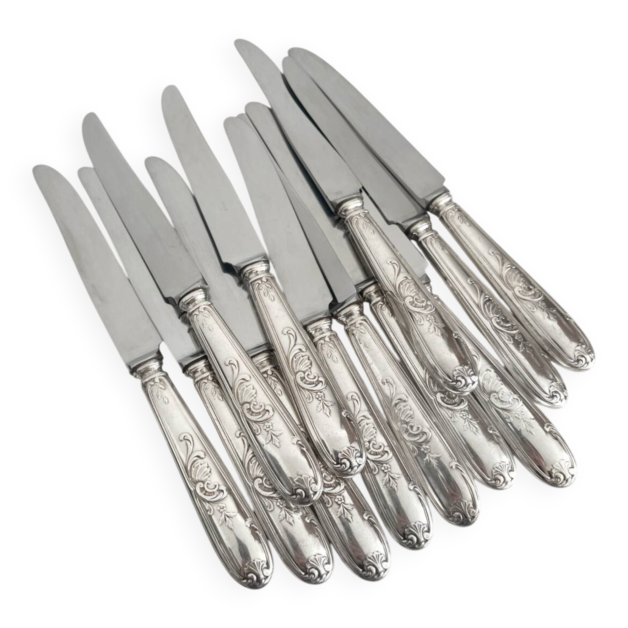 12 antique silver-plated knives with acanthus shell decoration and stainless steel blades.