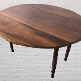 Oval walnut table with flaps