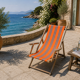 Vintage deck chair with orange and grey striped fabric, original patina.