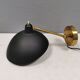 A wall lamp in black and brass-coloured finishes. Danish, early 2000s.