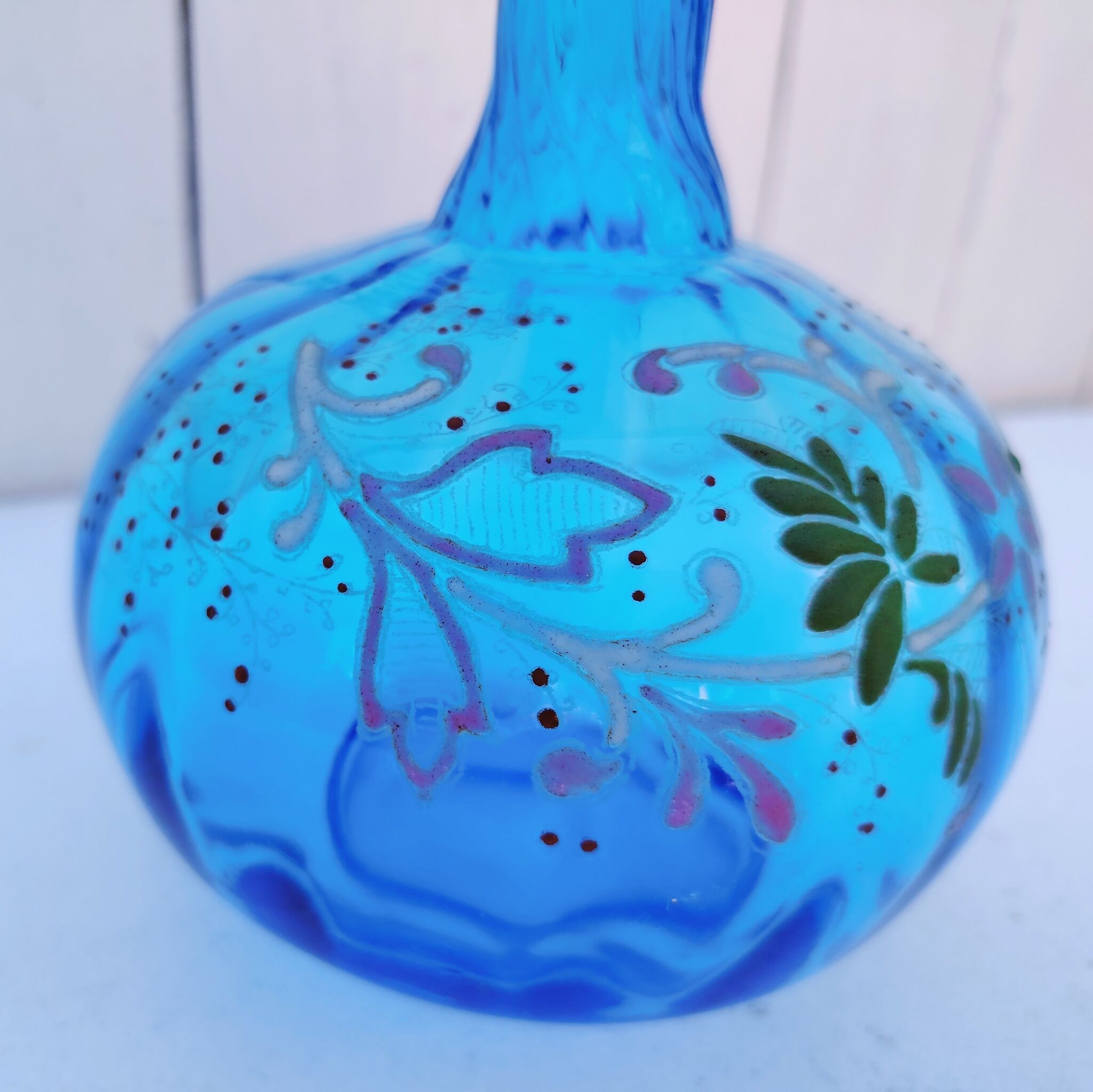 Vintage twisted blue glass carafe with enamel decoration.