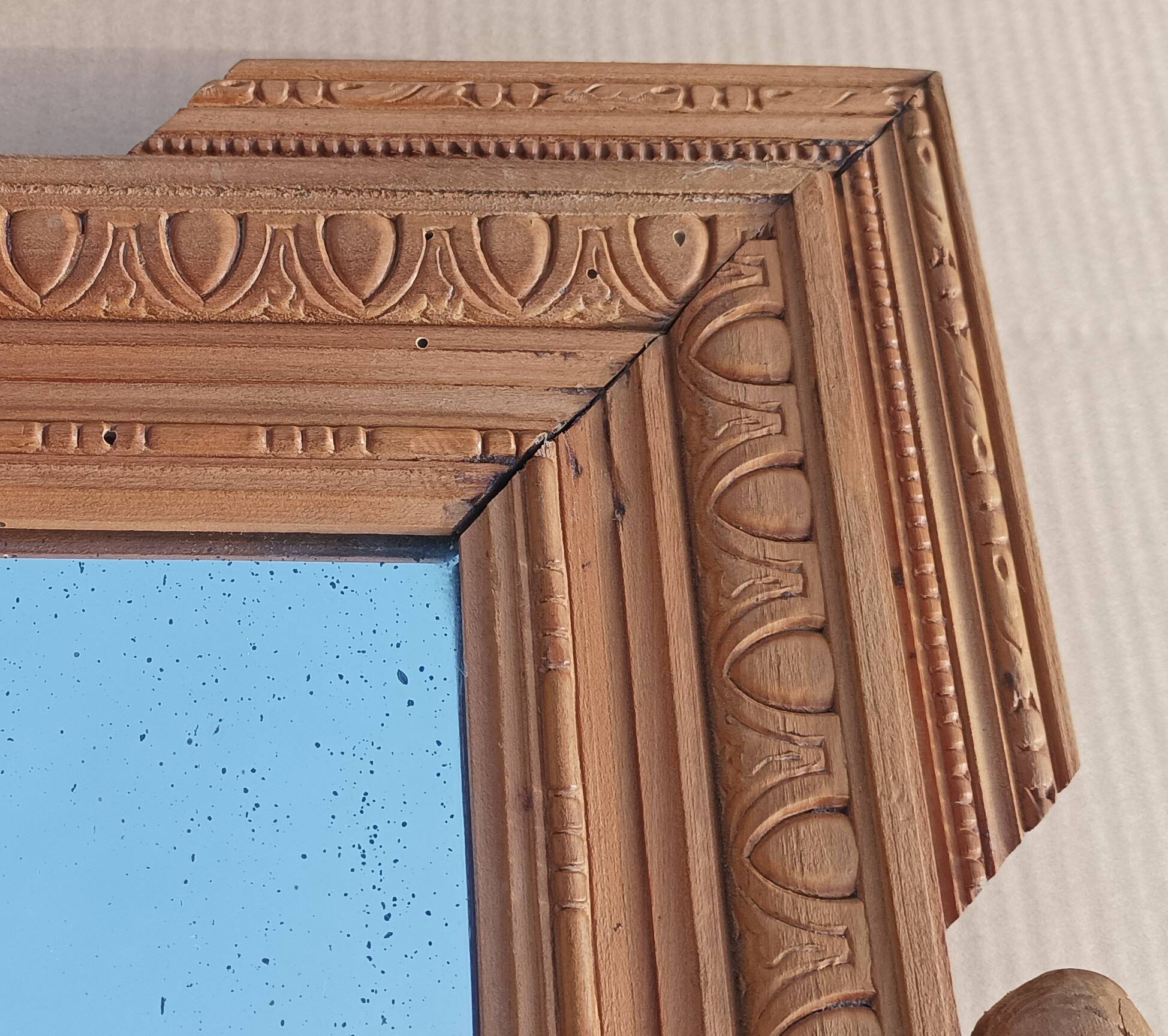 Louis XVI mirror in carved wood, 19th century.
