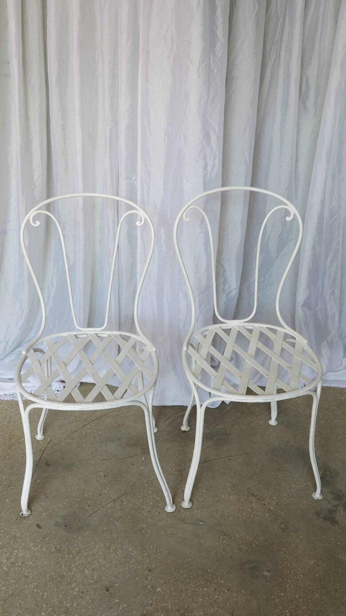 Pair of antique garden chairs, wrought iron, white paint.