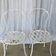 Pair of antique garden chairs, wrought iron, white paint.