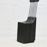 Brutalist chair, black-stained raw wood, steel. Work from the 1970s