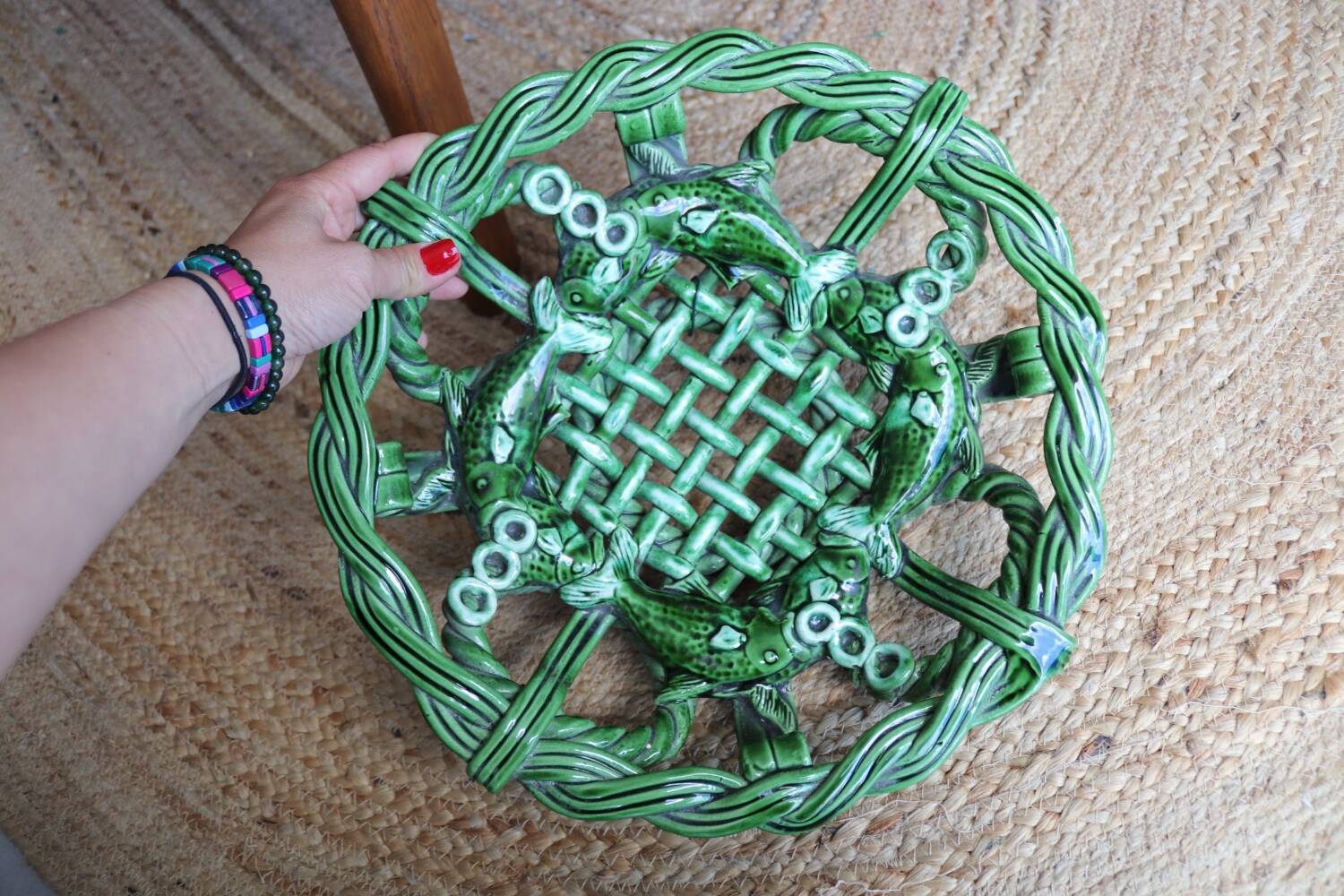 Antique woven basket in green glazed ceramic, fish decoration