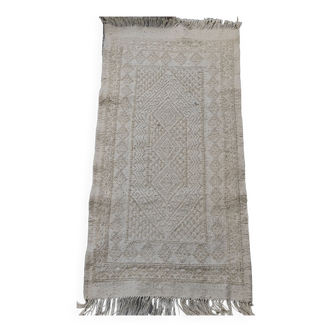 Hand-woven rug in natural wool