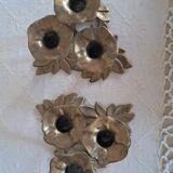 An antique pair of candlesticks with a floral design.