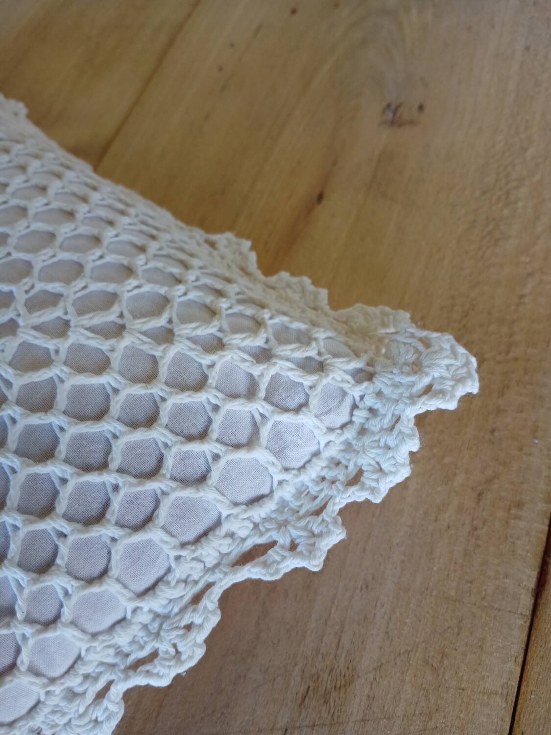 Cushion with white crochet cover