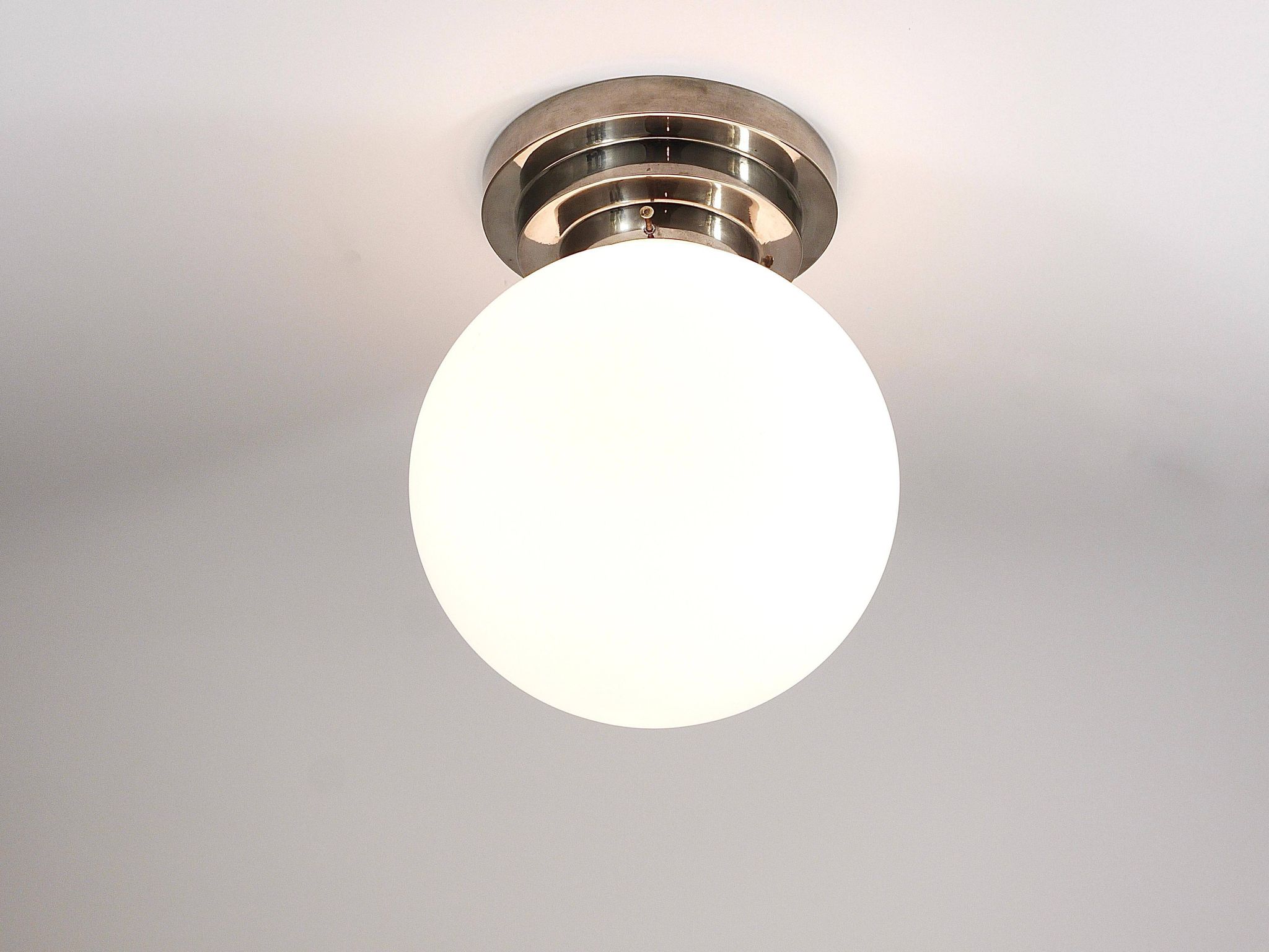 Large opaline glass globe ceiling lamp in Art Deco style.