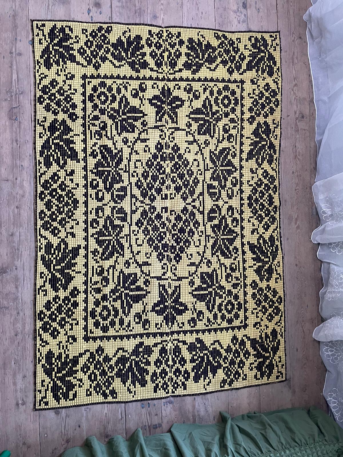 Romanian floral rug handwoven in wool, yellow and black background