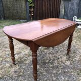 Louis Philippe oval shuttered table in solid cherry wood with 2 drawers.