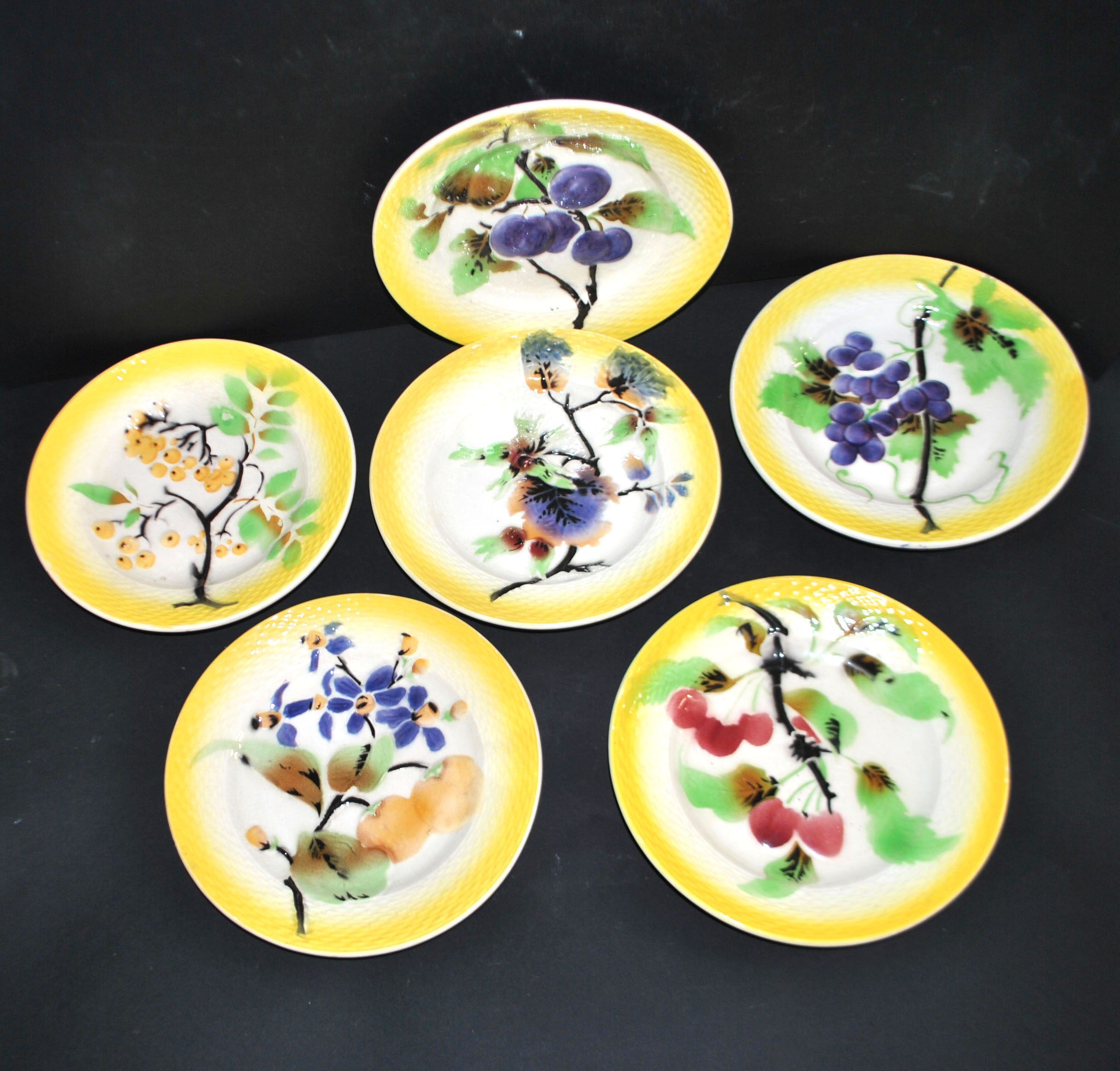 Orchies set of 6 yellow earthenware dessert plates with stencilled fruit decoration.