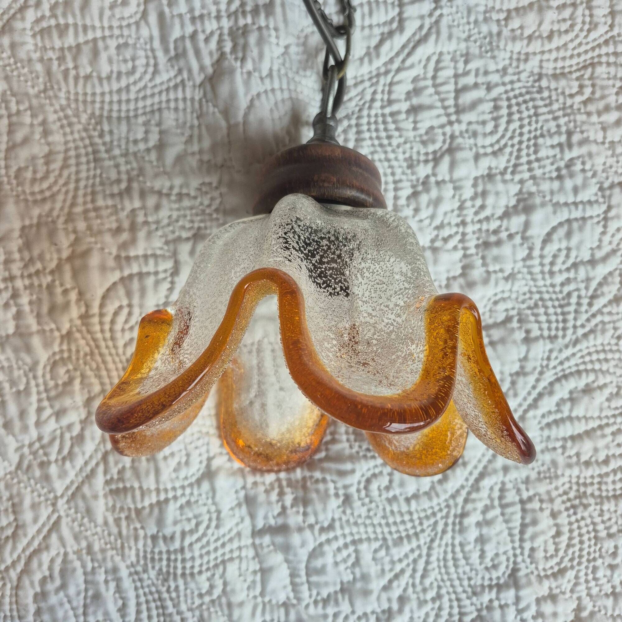 Vintage suspension with textured glass and amber-edged wood.